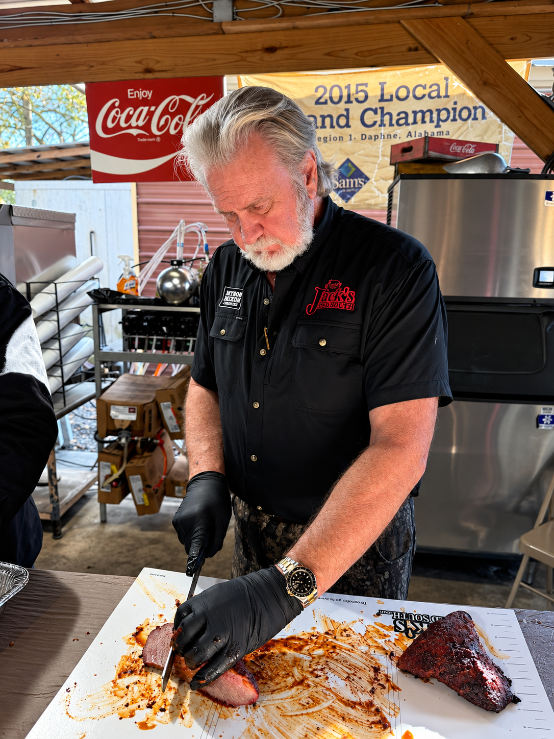 Myron Mixon slicing smoked brisket at a cooking demonstration